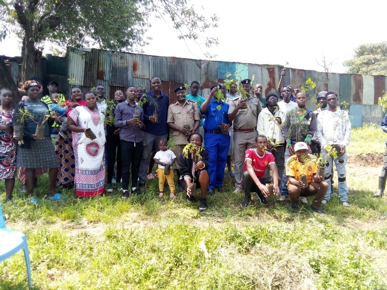 Community members holding seedlings at a tree planting